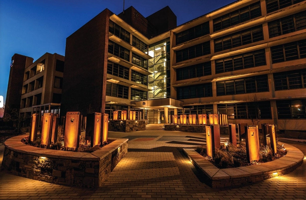Oklahoma Farm Bureau courtyard illuminated at night with uplighting on steel columns