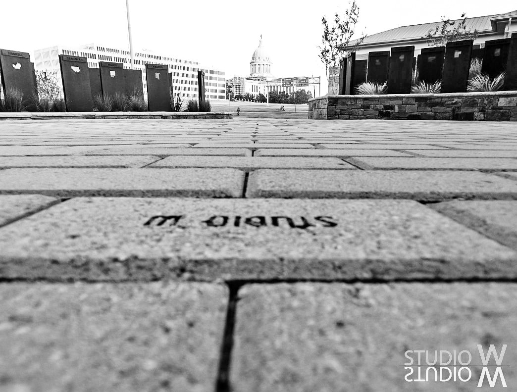 Black and white low-angle paver shot looking toward the Oklahoma State Capitol