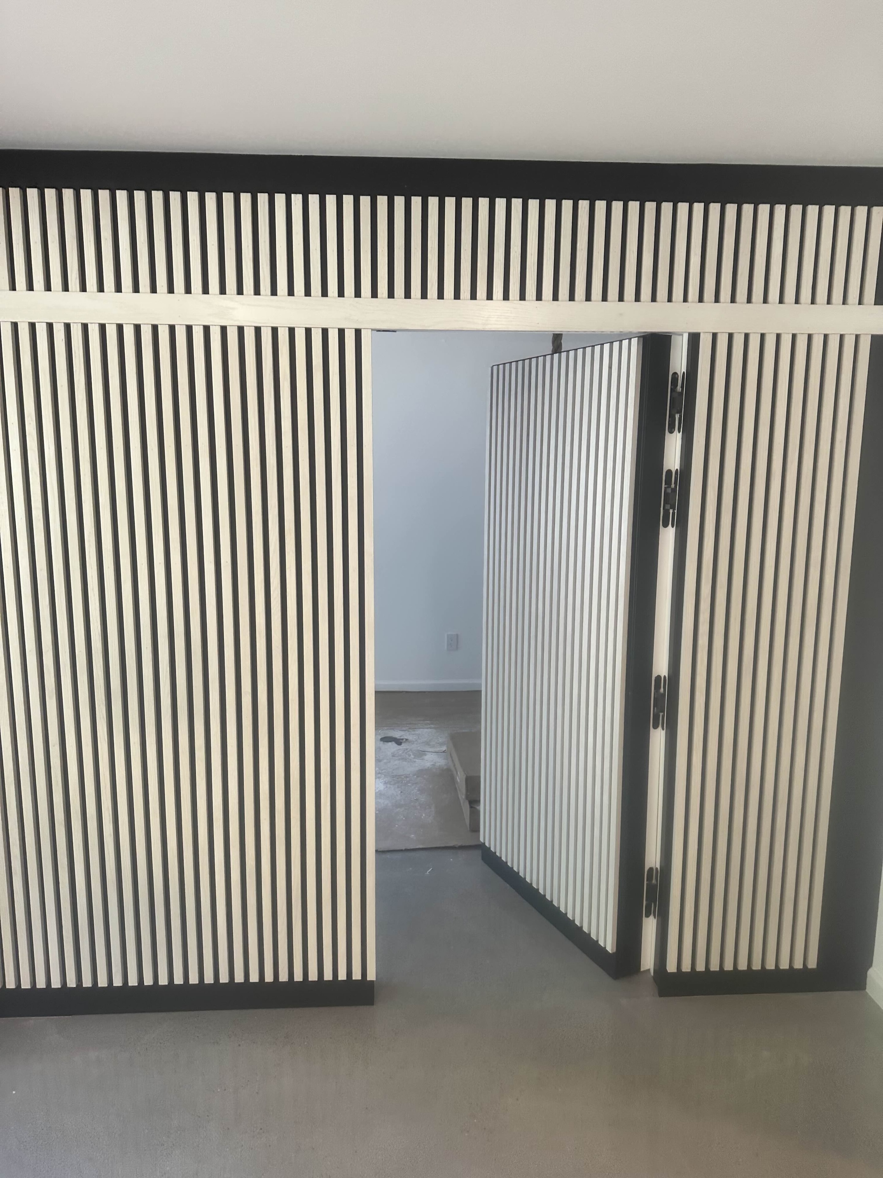 Hidden room revealed with ribbed panel doors swung open
