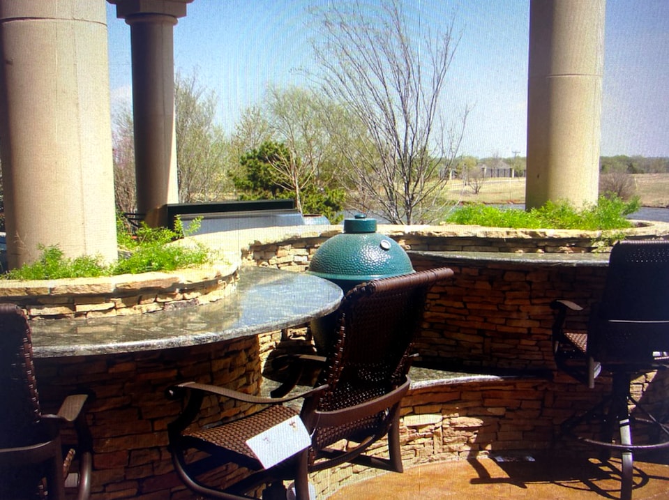Outdoor kitchen with Big Green Egg and stone columns