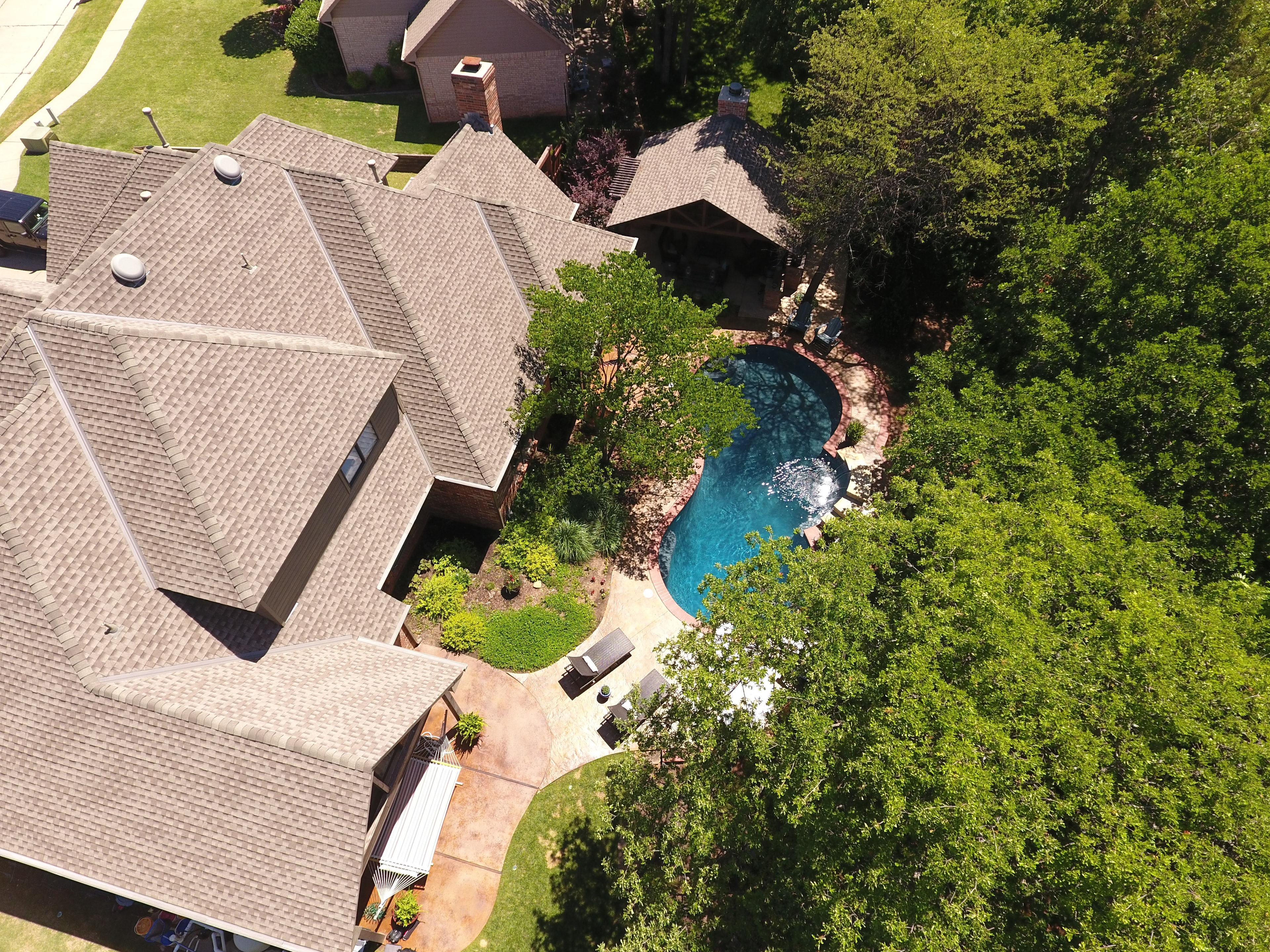 Aerial view of residential property with pool and landscaping