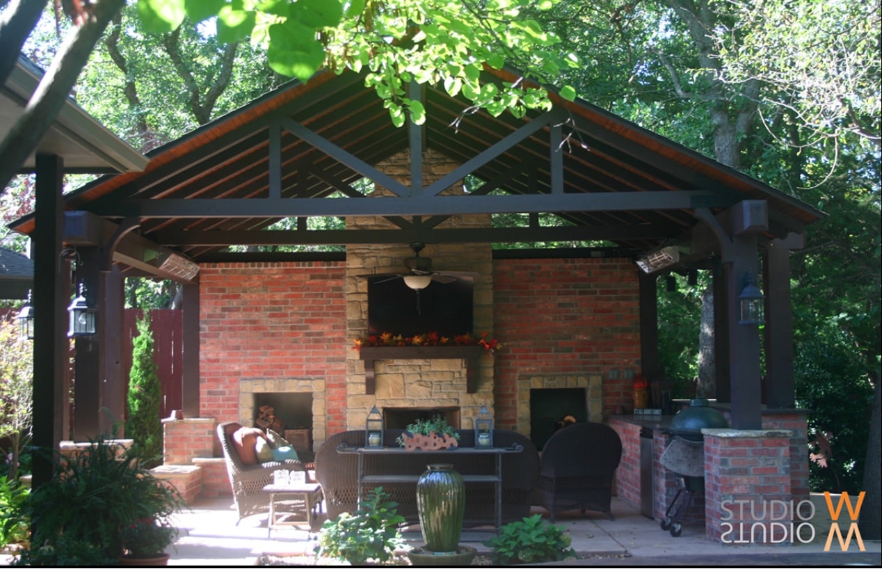 Old Towne steel-frame pavilion with brick fireplace, TV, Big Green Egg, and wicker seating